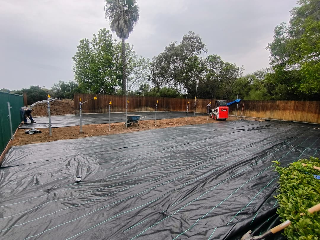 ground preparation and weed barrier installation in progress